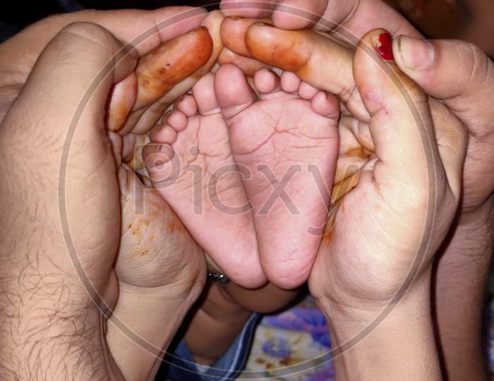 Parent Holding The Baby Toe In Hand Heart Shape Showing The Love
