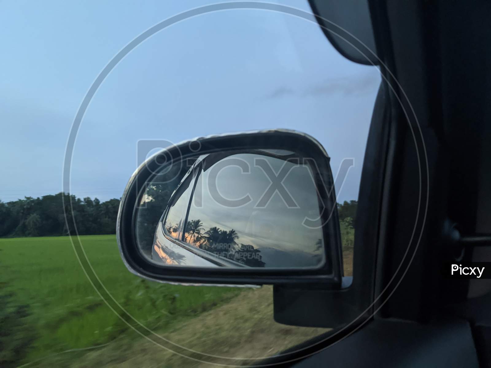 Sky view from car mirror