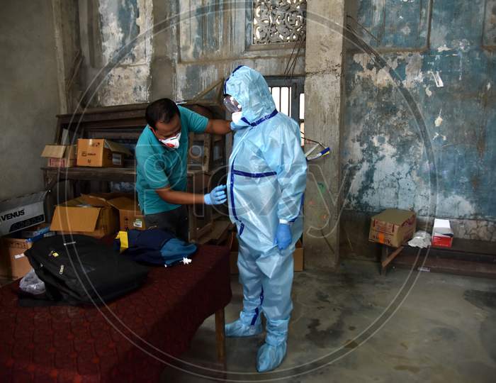An Indian Health worker wears a Personal Protective Equipment (PPE) before taking swab samples of people suspected for coronavirus COVID-19 Rapid Antigen detection testing in Nagaon District of Assam on Sep 08,2020