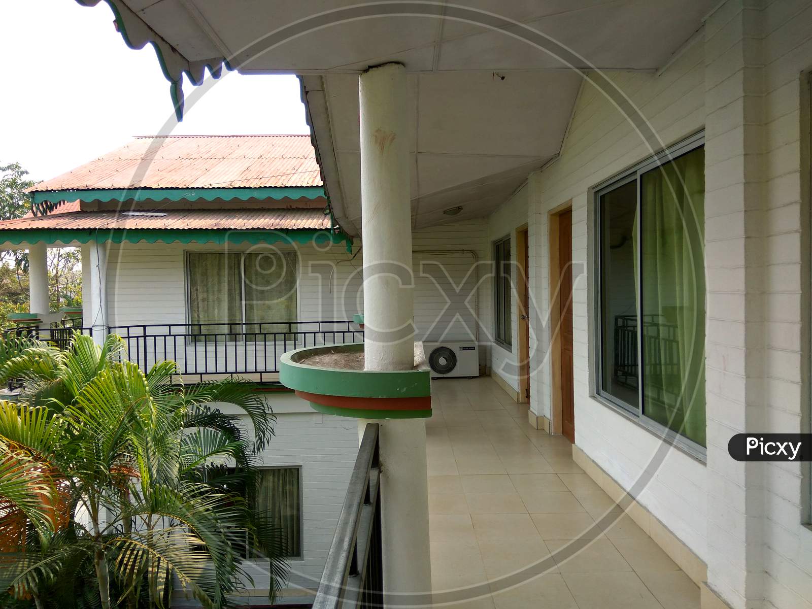 Balcony of a beautiful bungalow and big glass window rooms