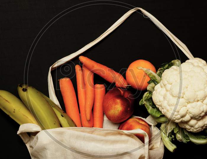 Top View Of Cloth Bag With Vegetables And Fruits Coming Out Of It. Zero Waste Concept. Flat Lay Flat Design