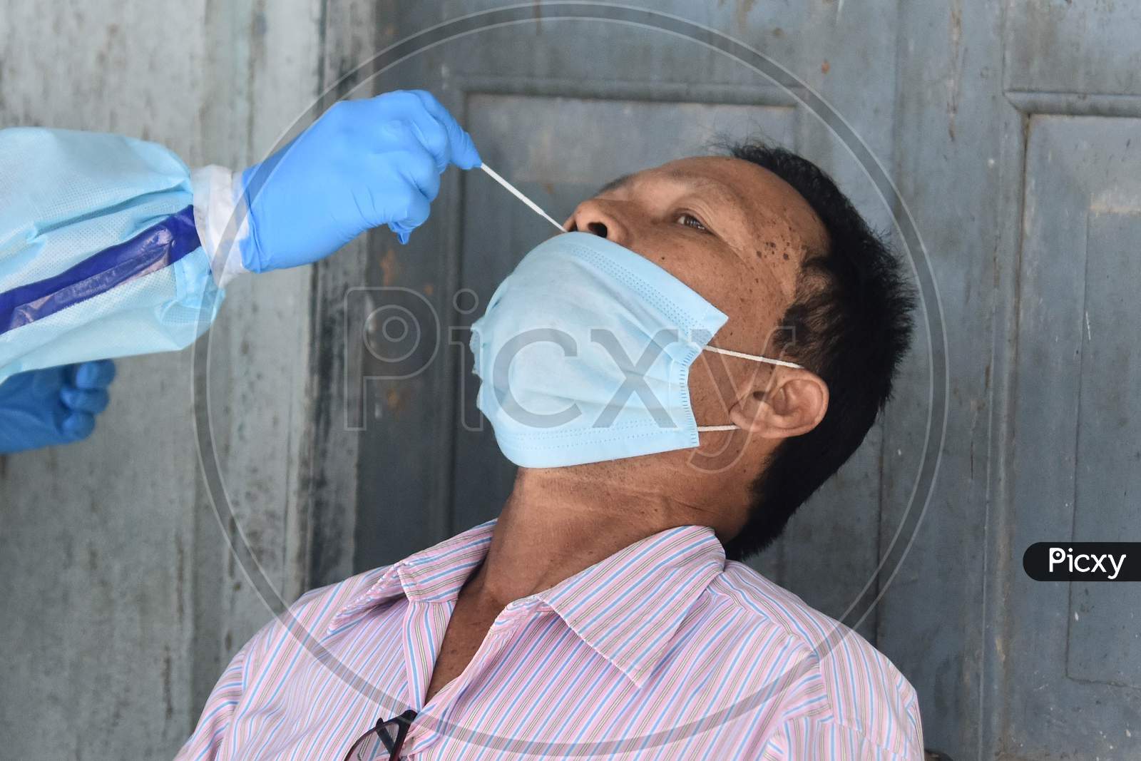 An Indian health worker takes a nasal swab sample to test for COVID-19 in Nagaon District of Assam on Sep 08,2020