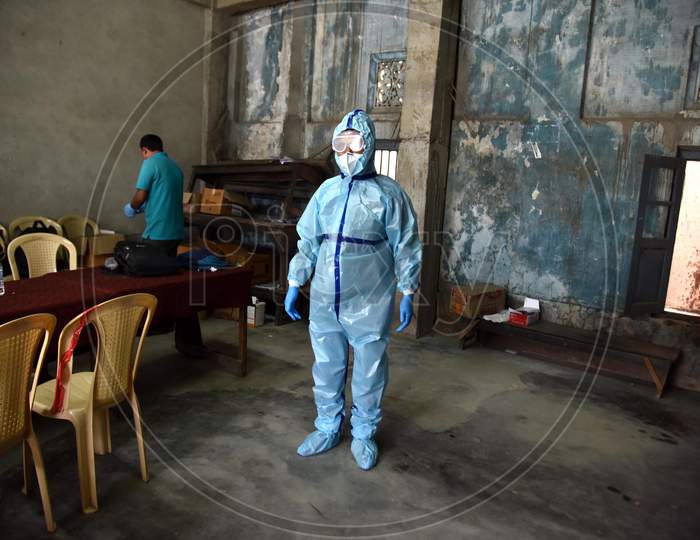 An Indian Health worker wears a Personal Protective Equipment (PPE) before taking swab samples of people suspected for coronavirus COVID-19 Rapid Antigen detection testing in Nagaon District of Assam on Sep 08, 2020