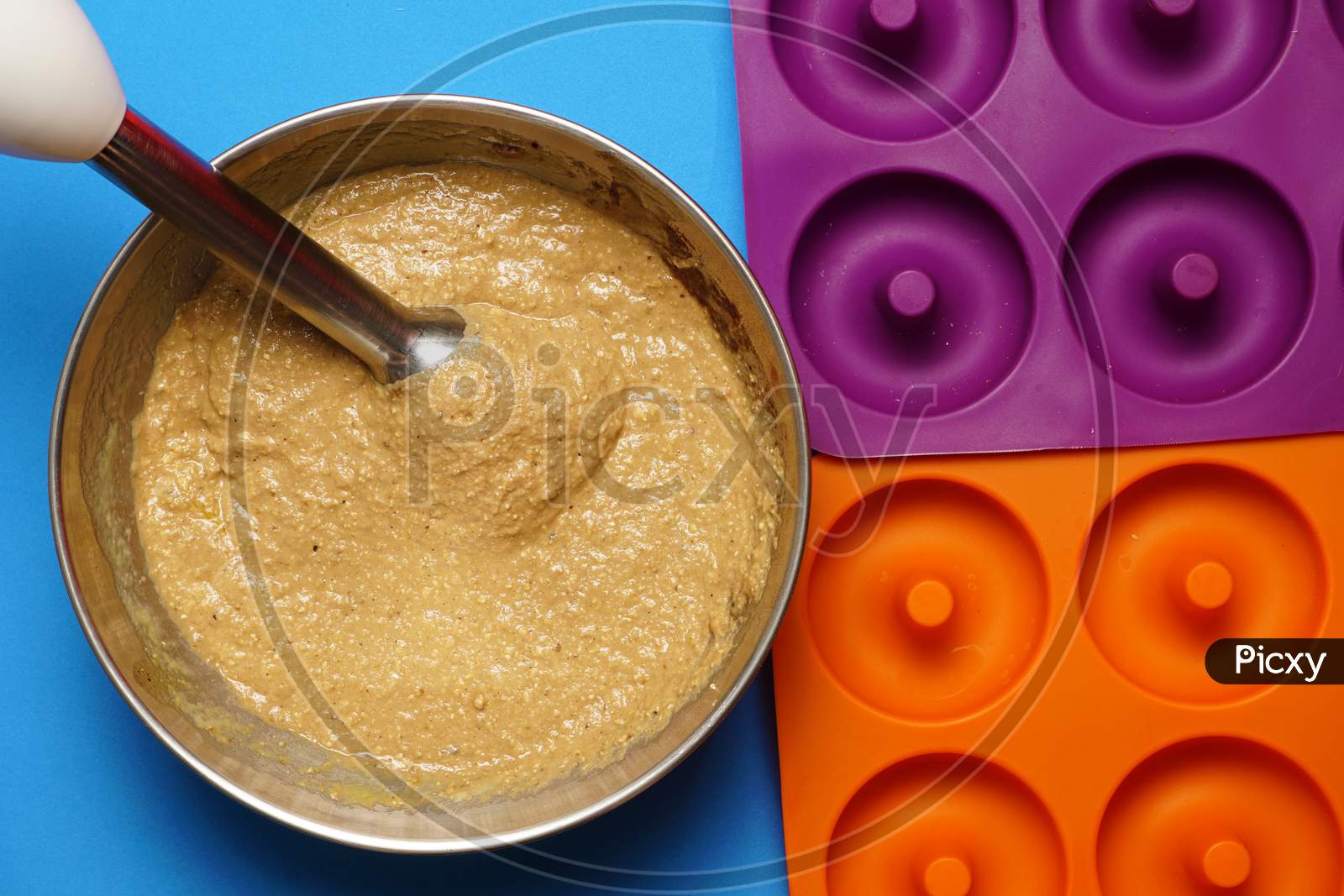 Top View Of Cake Mix In Bowl With Mixer And Molds Beside. Cooking Concept. Flat Lat Flat Design