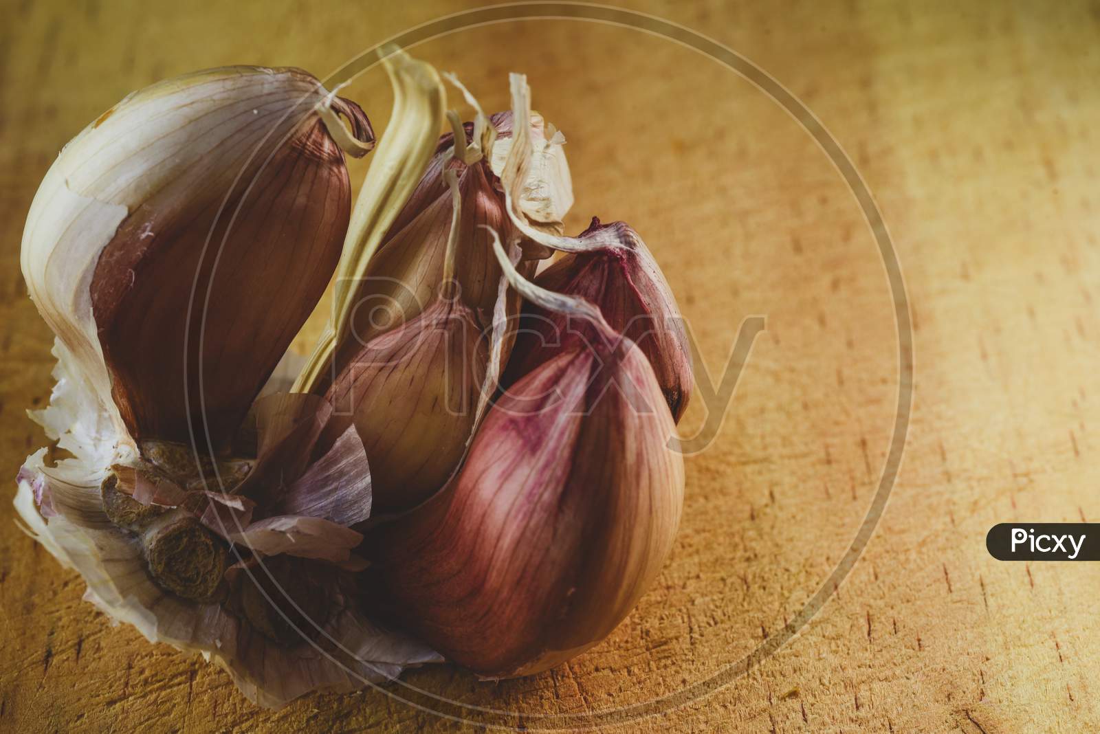Macro Close Up Of  Garlic / Clove On A Wooden Chopping Board