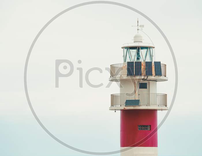 Minimalistic Close Up Of A White And Red Lighthouse With A Lot Of Copy Space