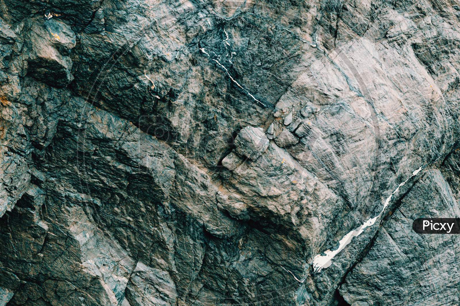 Flat Background Of A Grey Rock With Bluish Tones Over It