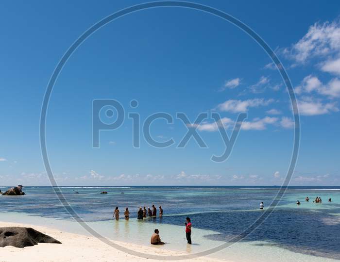 Tourists Enjoying A Sunny Day On The Beach