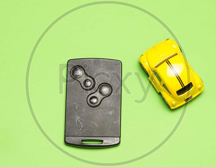 Top View Of Toy Car With Car Remote Control To The Side. Flat Lay Flat Design