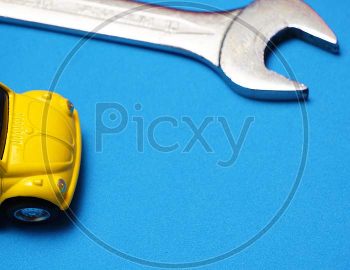 Top View Of Toy Car With Tool Beside. Repair Or Maintenance Concept. Flat Lay Flat Design