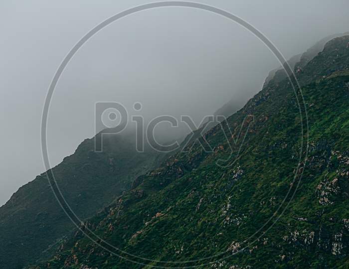 Close Up Of A Giant Green Mountain Surrounded By The Mist In Europe With Copy Space