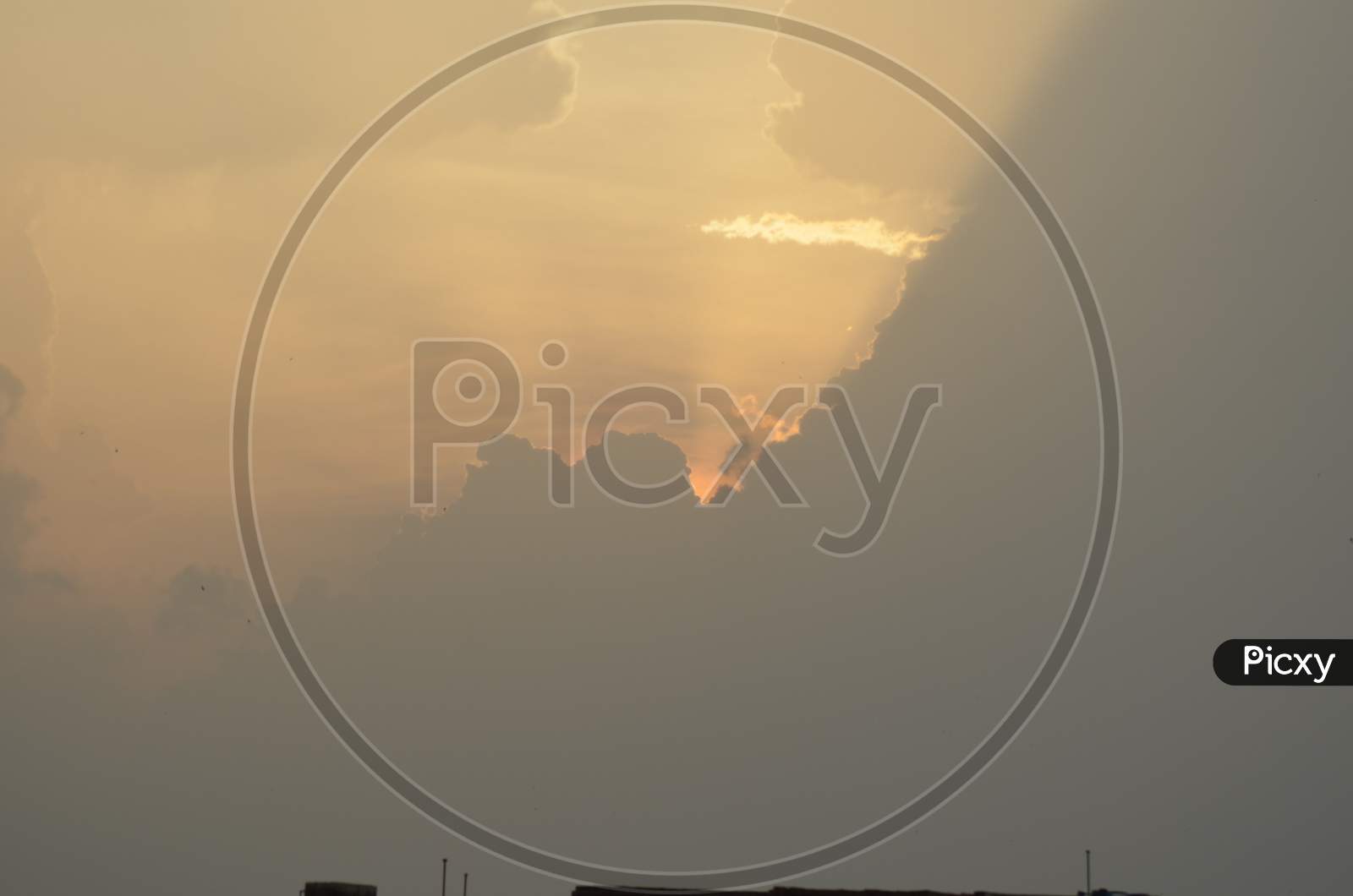 Sun hidden behind the clouds with scene photography