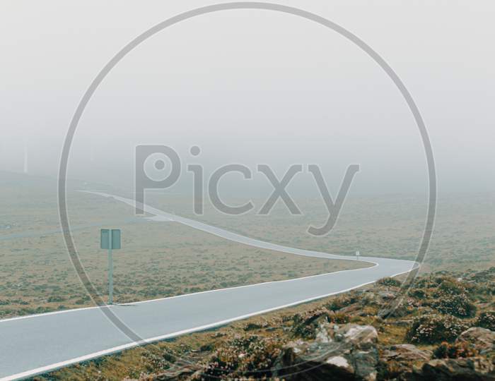 Solitary Road In The Middle Of The Mountain With A Lot Of Mist