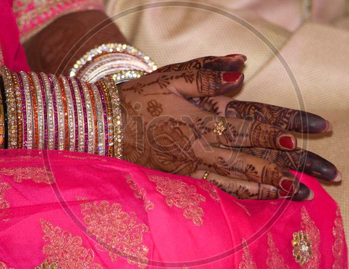 Hands with mehndi and bangles