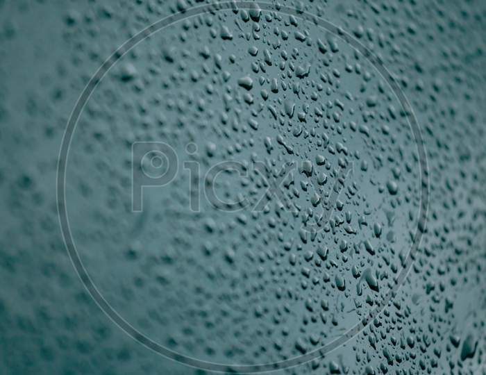 Flat Blue Background With A Lot Of Water Drops And Out Of Focus Surroundings