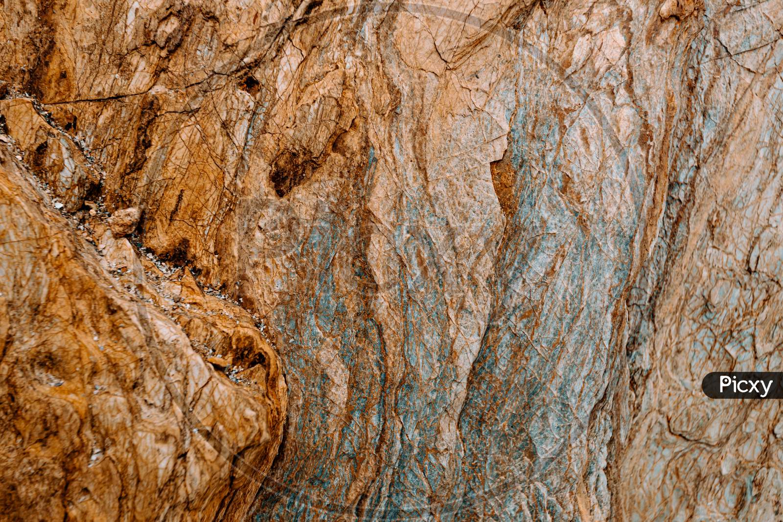 Flat Background Of A Brown With Blue Tones Rock With Rocky Texture