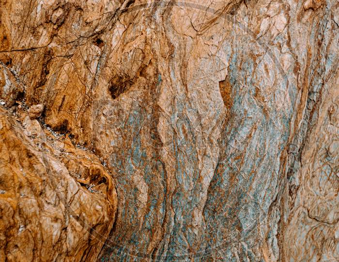 Flat Background Of A Brown With Blue Tones Rock With Rocky Texture