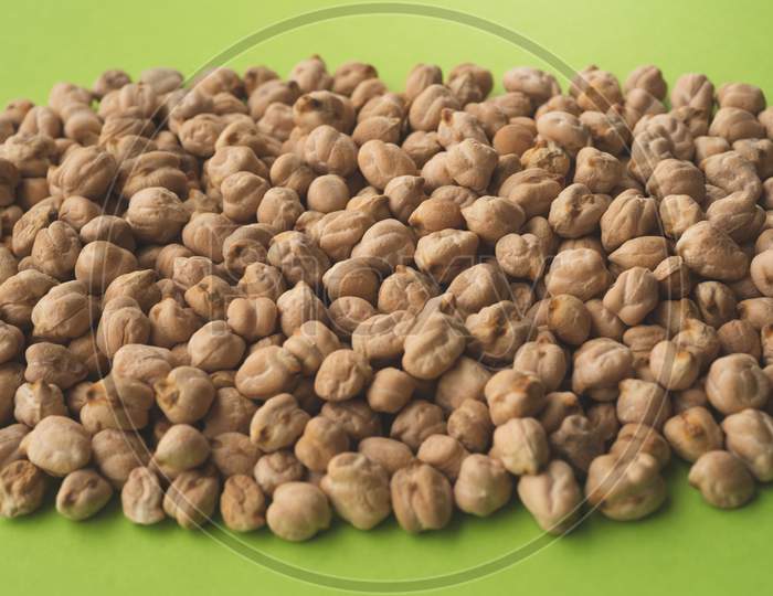 A Lot Of Raw Chickpeas On Green Background
