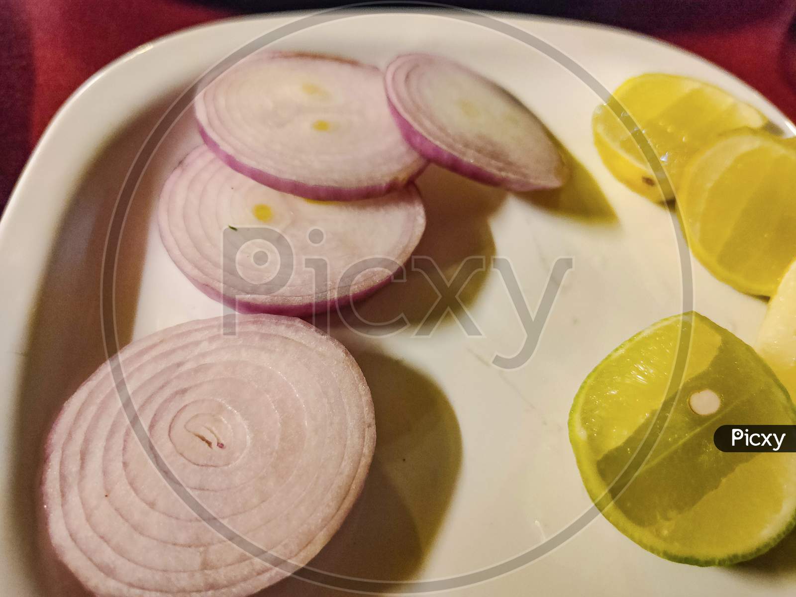 Picture Of Slice Onion And Fresh Juicy Lemon Kept In Plate.
