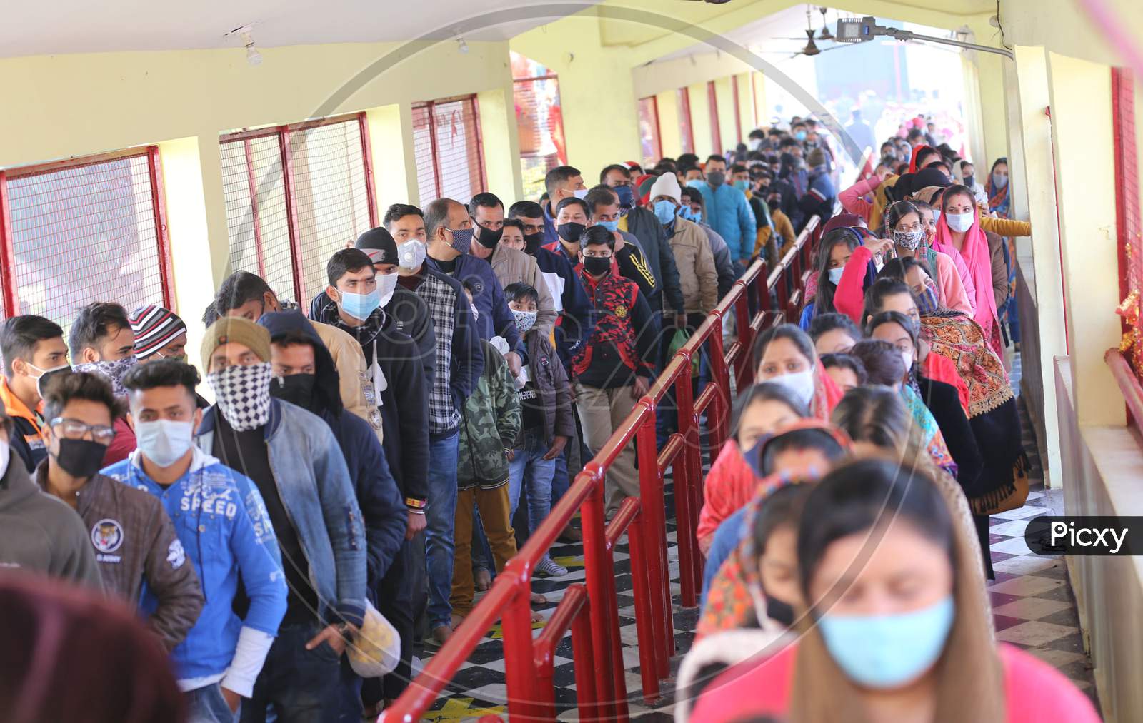 People stand in a queue , not adhering to social distancing norms, to pay obeisance at Kali Mata Temple on the first day of New Year 2021, in Jammu ,1 January,2021.