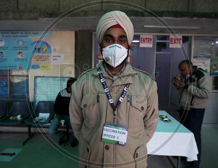 A Worker stands outside a vaccination center set up at a MCD maternity home ahead of a nationwide trial of a Covid-19 vaccine delivery system in New Delhi, India, on, Jan 1, 2021. India will test its Covid-19 vaccine delivery system with a nationwide trial on Jan 2