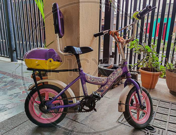 Bangalore , Karnataka , India- December 15Th 2020;Kids Purple Color Bicycle Parked In Apartment Parking Area In Bangalore City India