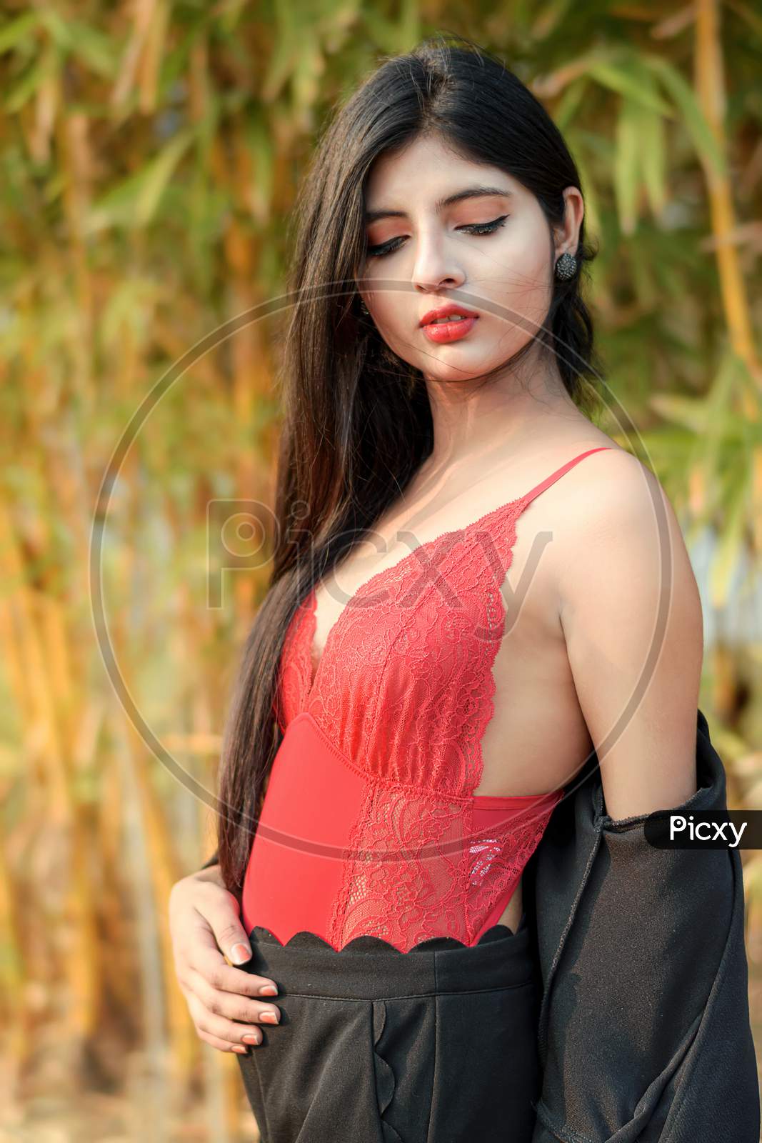 Portrait Of Very Beautiful Young Attractive Woman Wearing Red Outfit With Black Jacket Posing Fashionable In A Blurred Background. Lifestyle & Fashion.