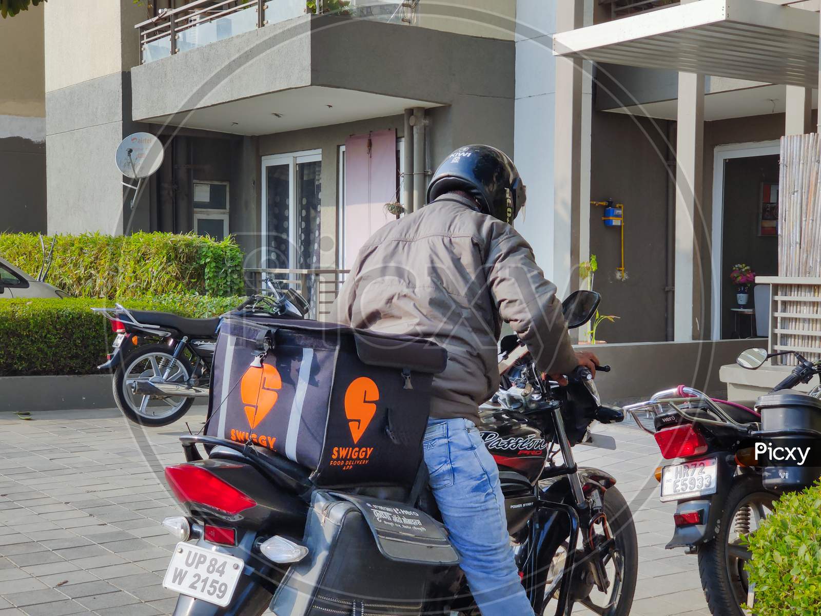 Rider On Bike With Black And Orange Swiggy Food Delivery Bag Hotcase Getting Ready To Deliver Food And Groceries For The Food Tech Unicorn Startup