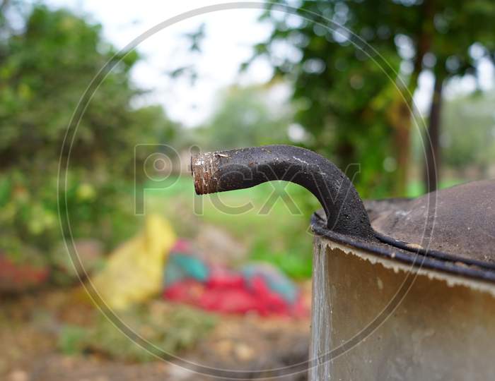 Selective Focus On Iron Pipe Connected With Water Heater With Blurred Background. Black Pipe View To Water Spring Out From Heater.