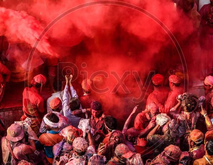 Mathura, Uttar Pradesh/ India- January 6 2020: Large Crowd Of Hindu Devotees With Colorful Powder Celebrating Traditional And A Ritualistic Holi In Temple At Mathura. People Clicking Picture.
