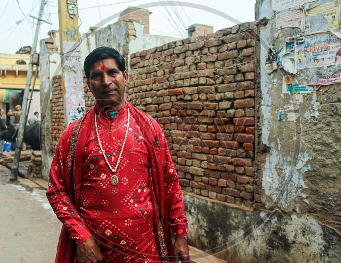 Mathura, Uttar Pradesh/ India- January 6 2020: A Man Wearing Indian Traditional Costume With Black Hair Standing On Mathura Street During Holi Festival.