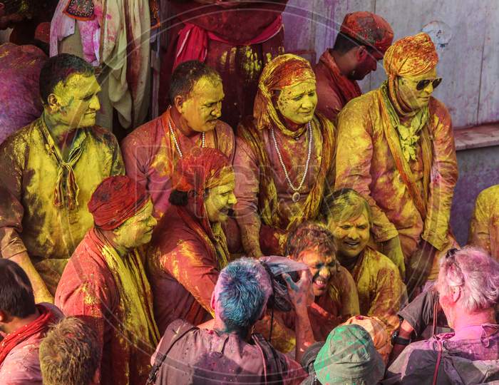 Mathura, Uttar Pradesh/ India- January 6 2020: Group Of Happy Friends Playing With Holi Colors Faces,Adults Having Fun At A Holi Festiva ,Foreigners Enjoying Festival In India And Foreigners Clicking Photos.
