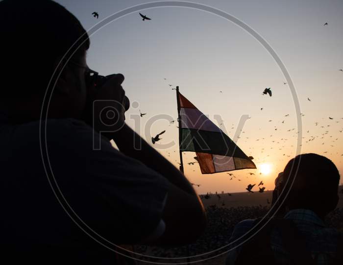 Photographer clicking Indian Flag during Sunrise