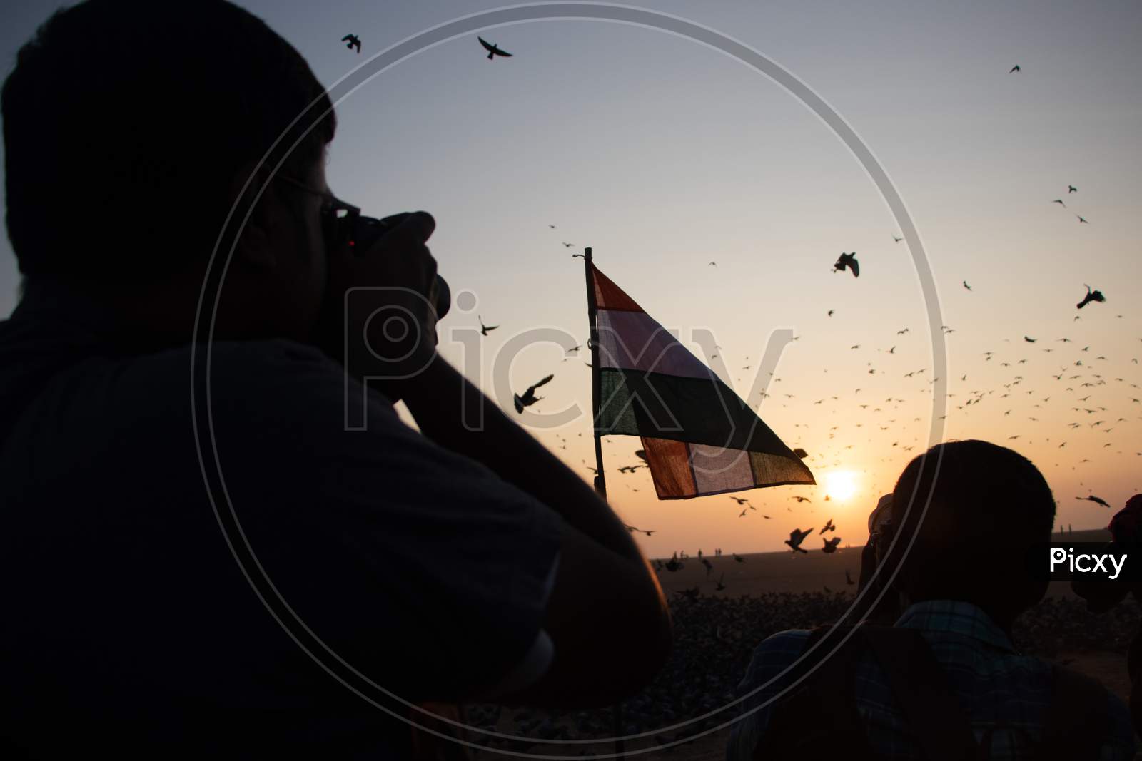 Photographer clicking Indian Flag during Sunrise