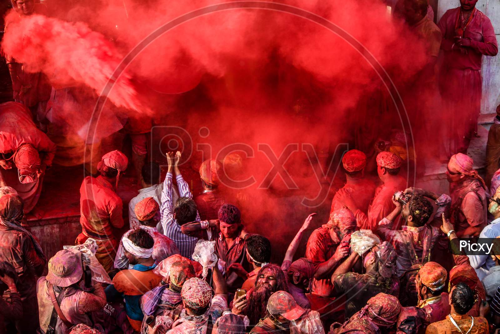 Mathura, Uttar Pradesh/ India- January 6 2020: Large Crowd Of Hindu Devotees With Colorful Powder Celebrating Traditional And A Ritualistic Holi In Temple At Mathura. People Clicking Picture.