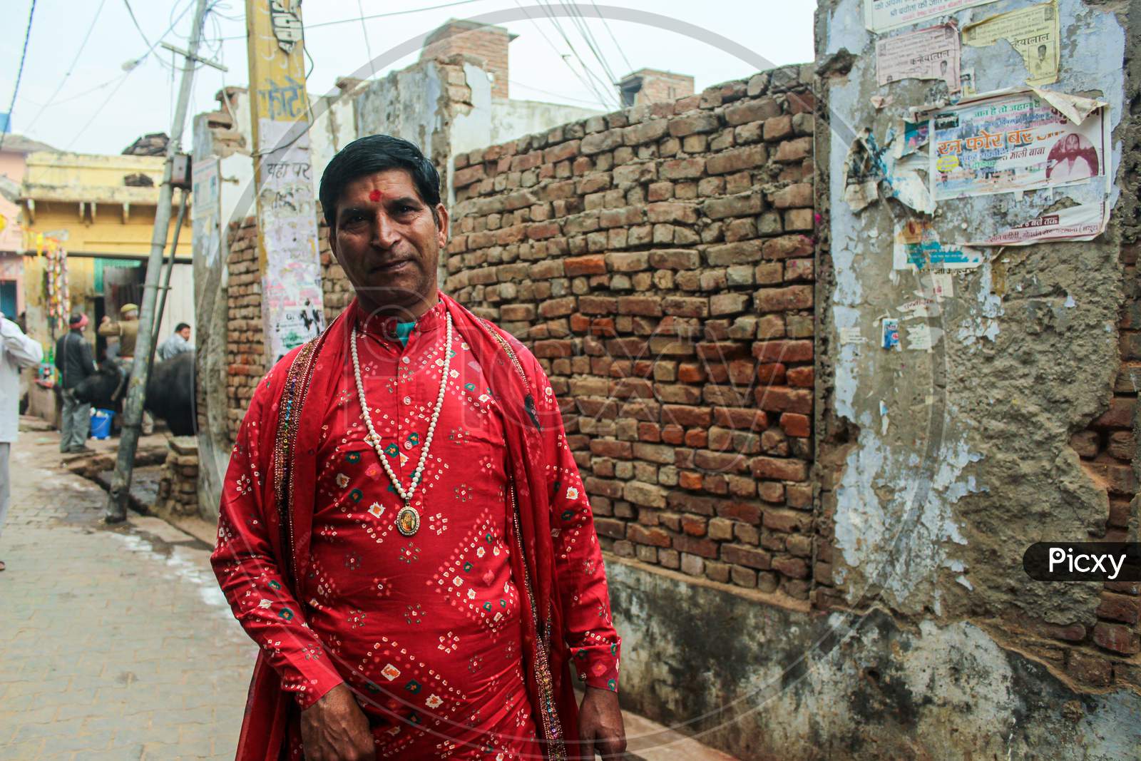 Mathura, Uttar Pradesh/ India- January 6 2020: A Man Wearing Indian Traditional Costume With Black Hair Standing On Mathura Street During Holi Festival.