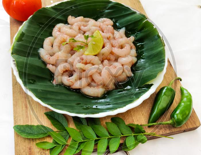 Fresh Raw Ready To Cook Pink Shrimp Decorated With Herbs And Vegetables,Selective Focus.White Background.