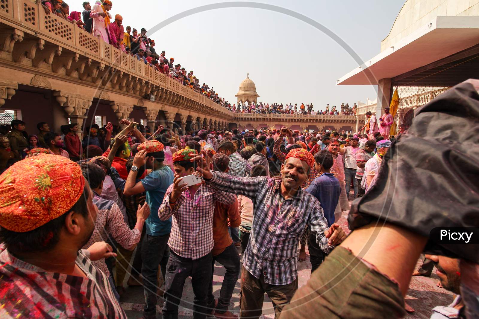 Mathura, Uttar Pradesh/ India- January 6 2020: Large Crowd Of Hindu Playing With Colourful Powders , Dancing Full Of Enjoyment And Celebrating Holi In Temple At Mathura . Sharing Love , Faces Smeared With Color