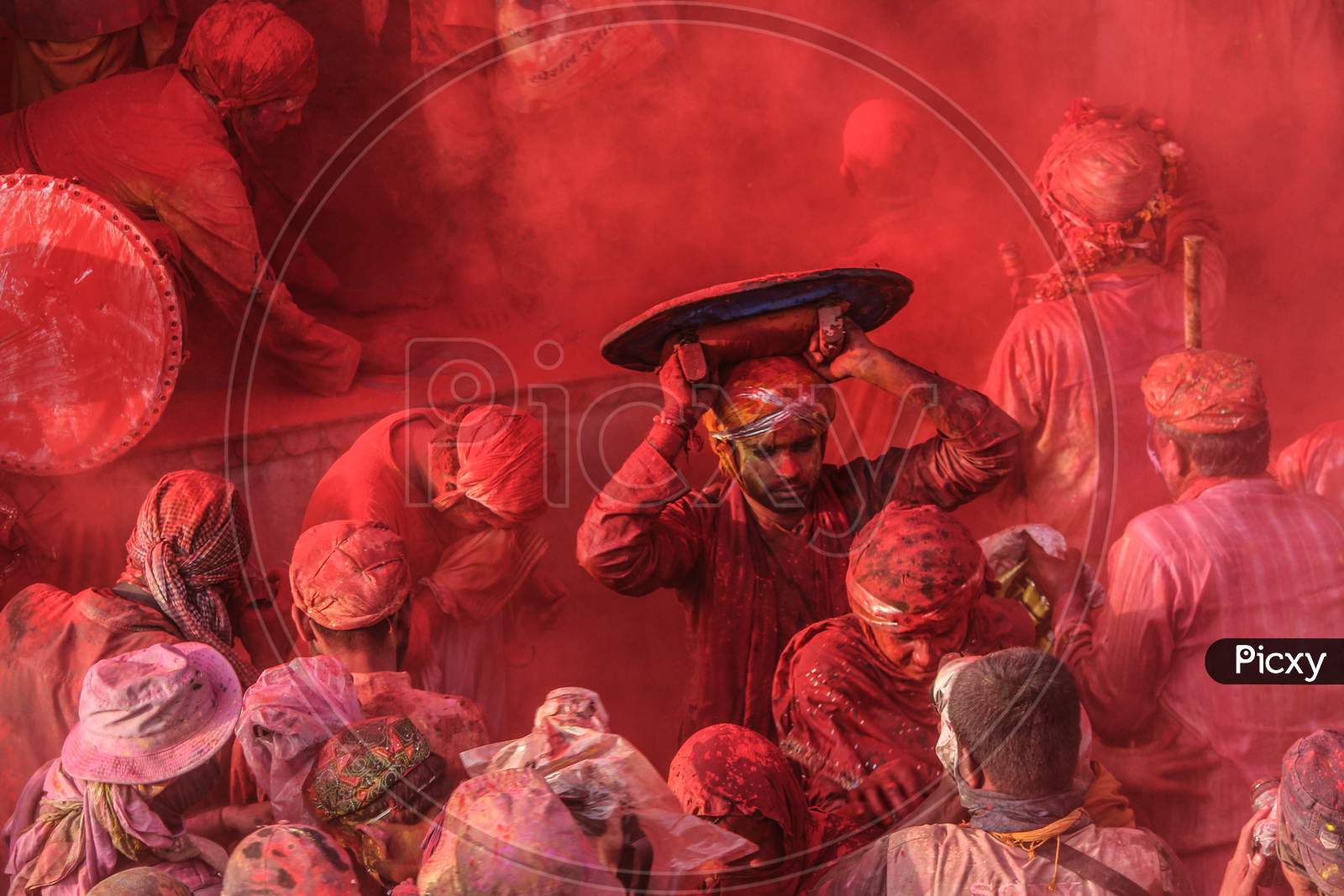Mathura, Uttar Pradesh/ India- January 6 2020: People Celebrate The Traditional And A Ritualistic Holi Praying To God At Temple. During Holi Festival. Clicking Photos Holding Stick, Holi Colorful Festival In India.