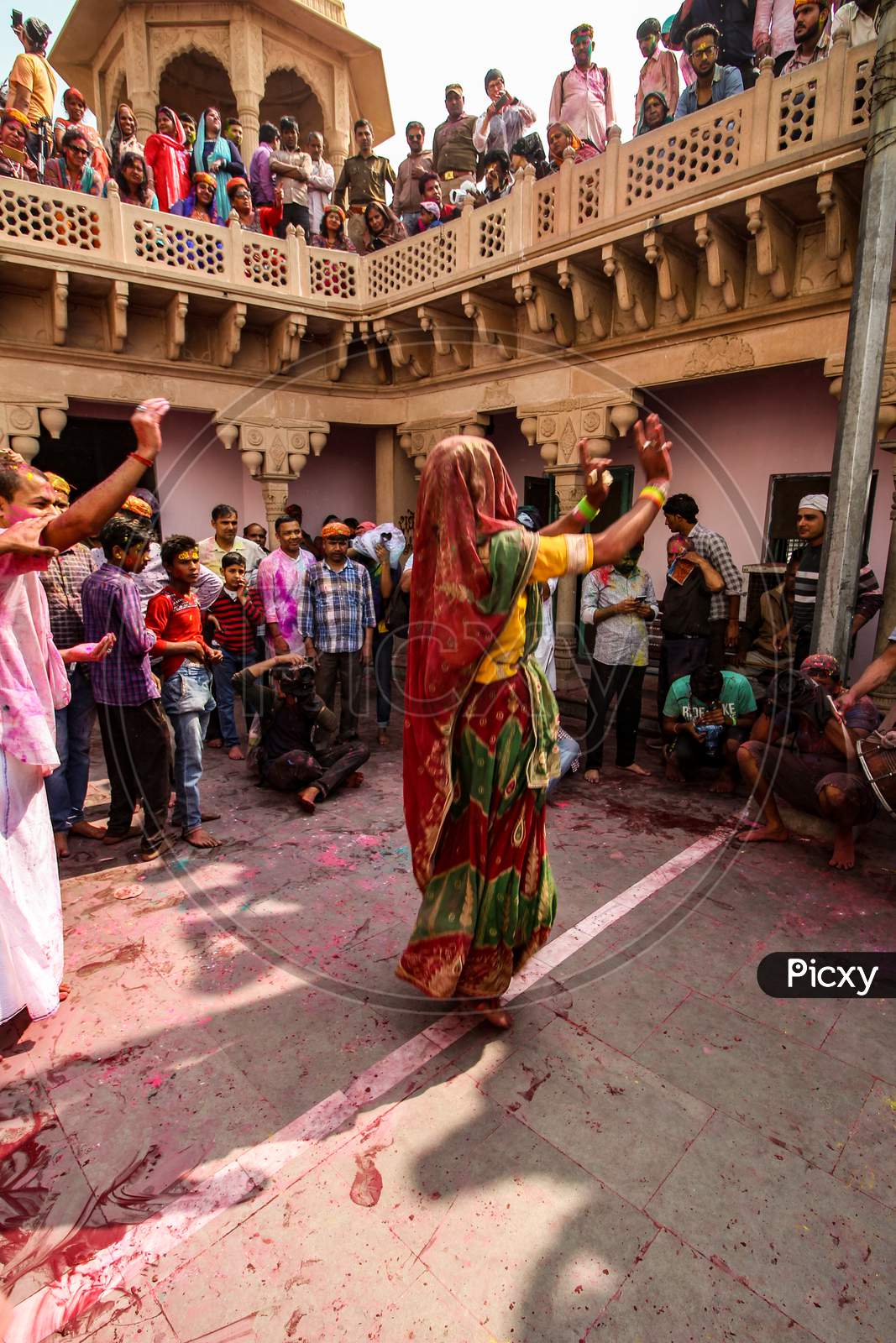 Mathura, Uttar Pradesh/ India- January 6 2020: : Woman Dance Performing At Holi Festival Wearing Traditional Dress People Looking Her,Throwing Color And Clicking Photos.