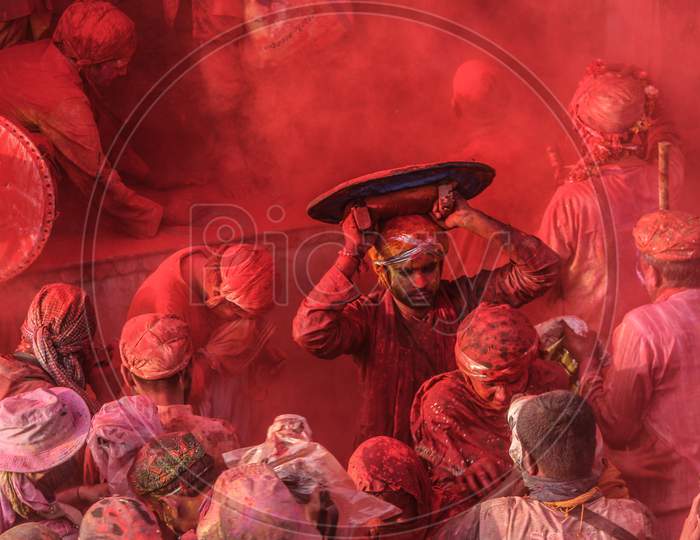 Mathura, Uttar Pradesh/ India- January 6 2020: People Celebrate The Traditional And A Ritualistic Holi Praying To God At Temple. During Holi Festival. Clicking Photos Holding Stick, Holi Colorful Festival In India.