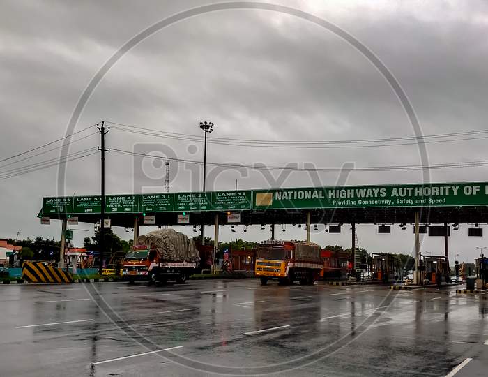 Perambalur , Tamil Nadu, India - December 4Th 2020: Busy Fastag Highway Toll Gate Checkpoint On Monsoon Rainy Day. Truck And Car Cross Highway Freeway Toll Gate.