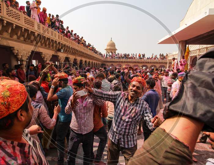 Mathura, Uttar Pradesh/ India- January 6 2020: Large Crowd Of Hindu Playing With Colourful Powders , Dancing Full Of Enjoyment And Celebrating Holi In Temple At Mathura . Sharing Love , Faces Smeared With Color