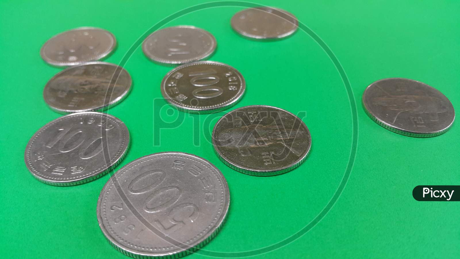 Korean Won Coin Scattered Over A Green Floor