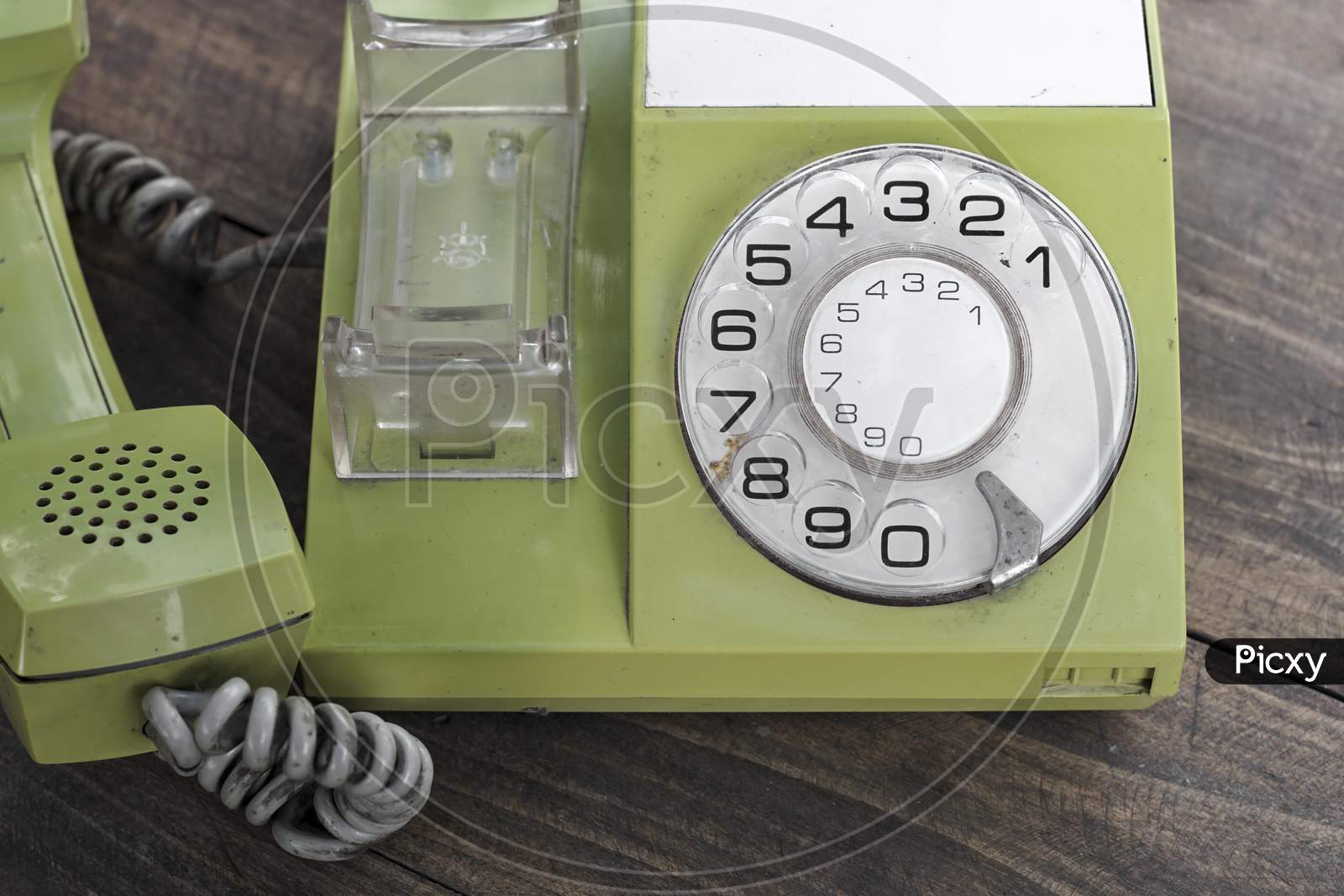 Green Old-Fashioned Telephone On Wooden Background