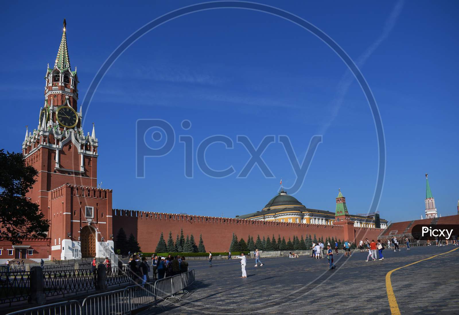 People Walk On Red Square On A Sunny Day