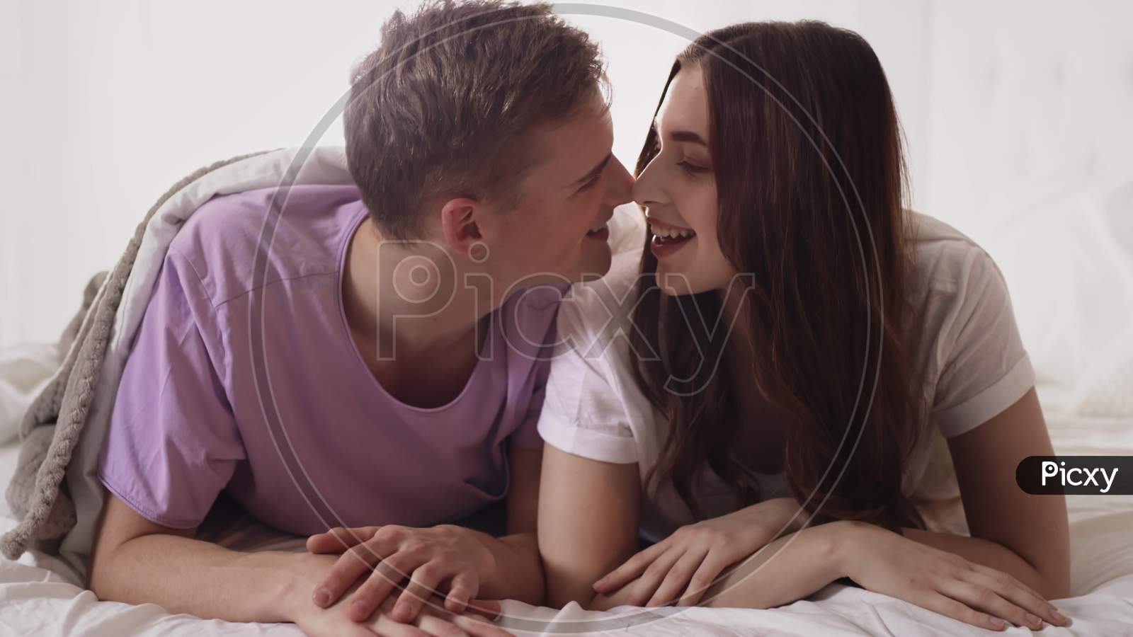 Couple Cuddling In Bed. Couple In Bed Morning