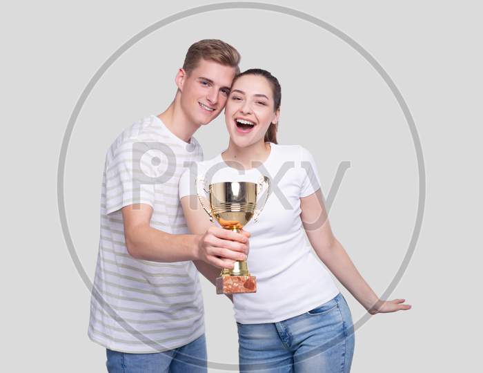 Couple Holding Trophy Happy Isolated. Couple Goals. Winners