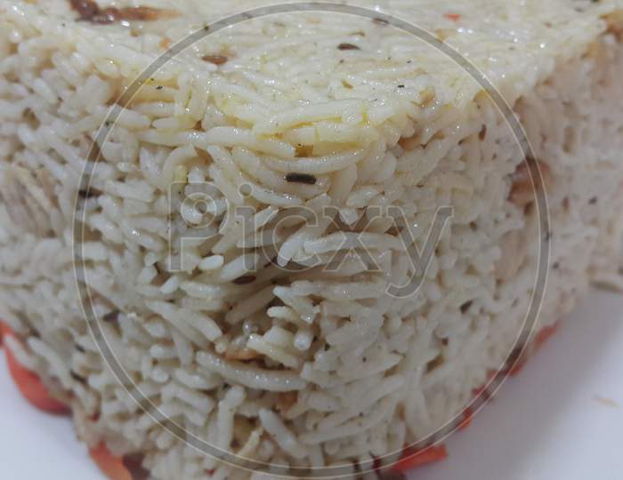 Closeup Of Frozen White Rice Cake In A White Plate Over Wooden Floor