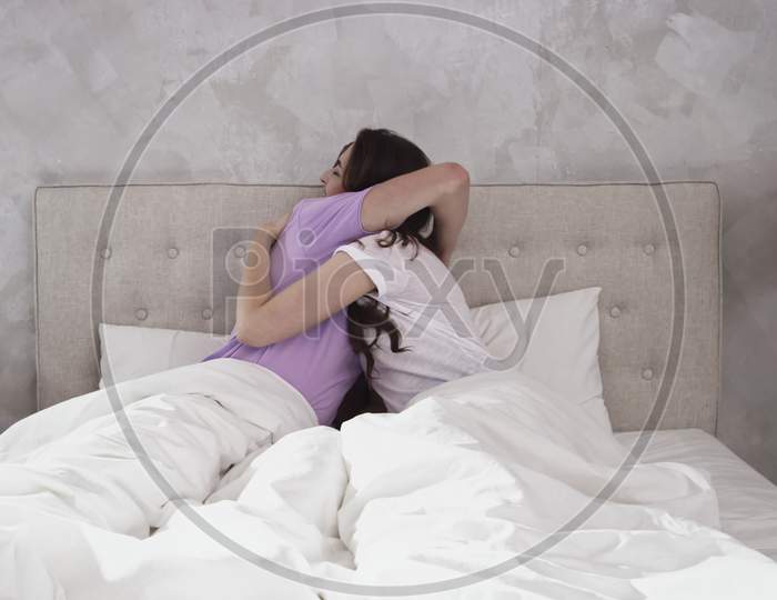 Couple Cuddling In Bed. Couple In Bed Morning